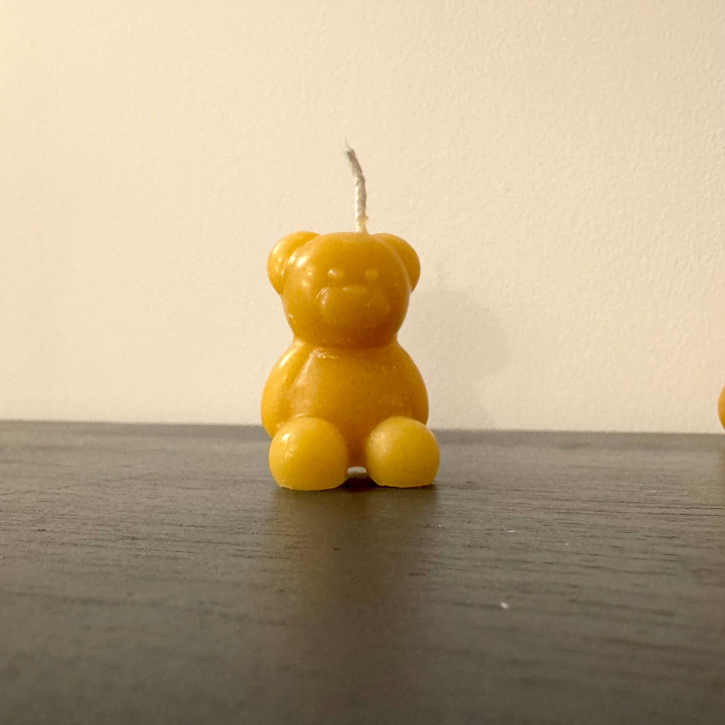 A little bear is made out of beeswax, a small beeswax bear candle