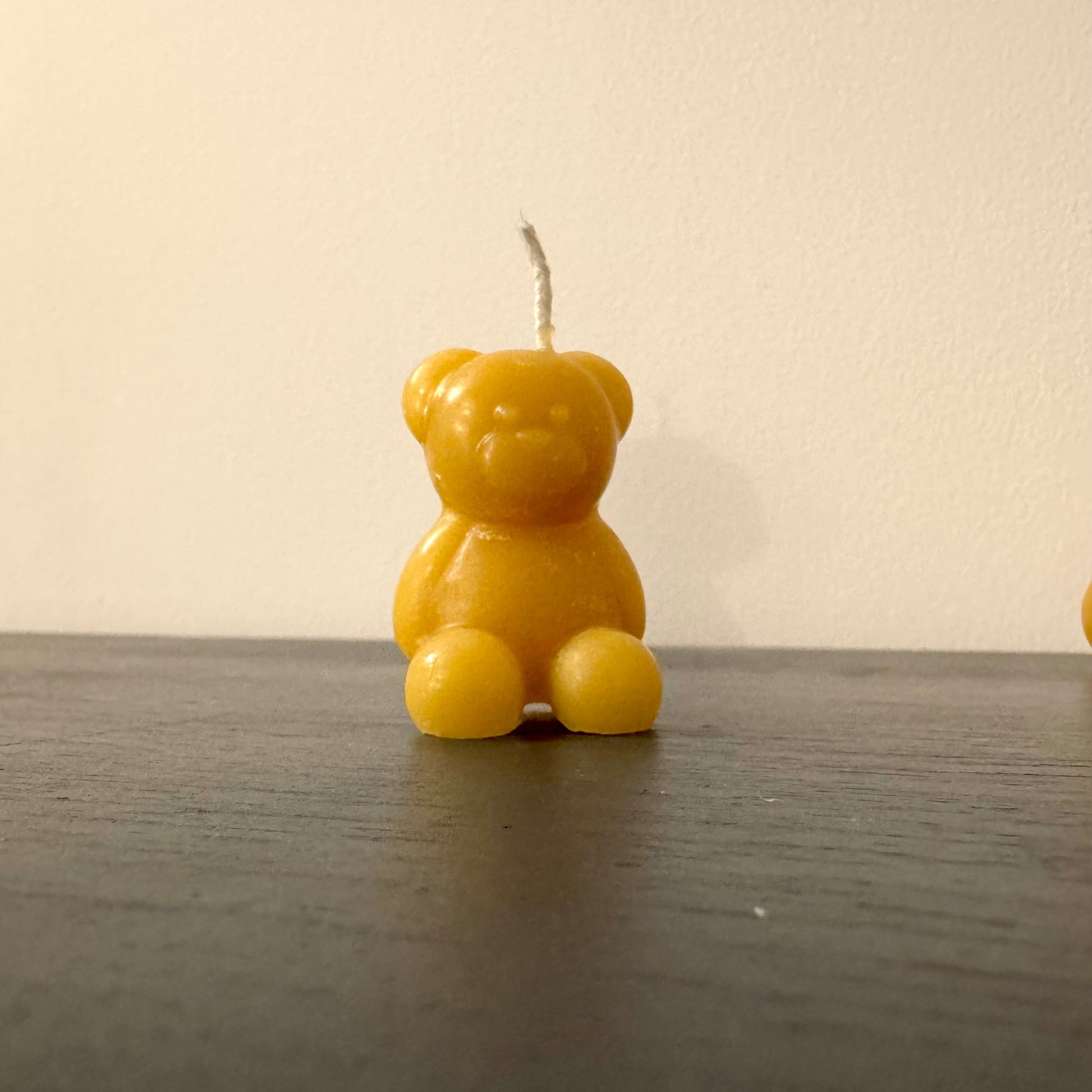 A little bear is made out of beeswax, a small beeswax bear candle